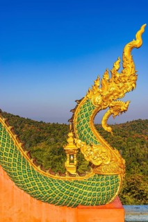 Gilded dragon figure at the stairway to the Buddhist temple Wat Phra That Don Phra Chan, near