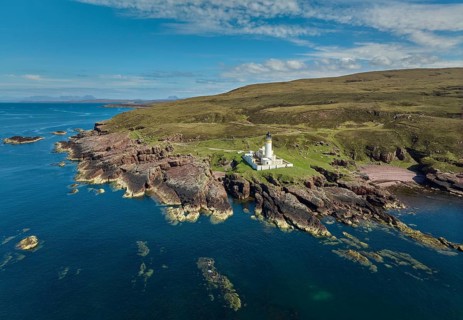 Aerial photo of the lighthouse on the rocky red cliffs of Rua Reidh point, Gairloch, Scotland, UK