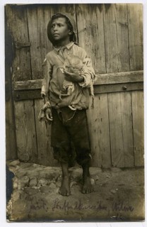 Jewish beggar, boy, Vilnius, Lithuania, poverty, hunger, orphan, boy in tattered clothes holding