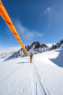 Ski tourer with rope, rope team on the Vadret da Porchabella glacier on the ascent to the summit of