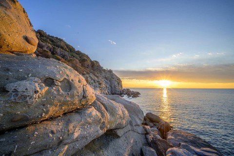 Rock formations in the evening light on, Capo Sant Andrea, Marciana, Livorno Province, Italy