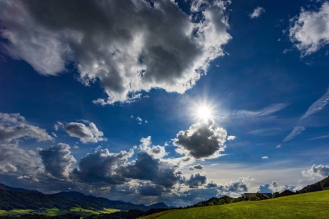 Meadow with dramatic cloudy sky, agricultural landscape, Mondseeland, Salzkammergut, Austria