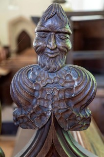 Carved wooden poppyhead face of man with beard, village parish church of Saint Andrew, Winston,