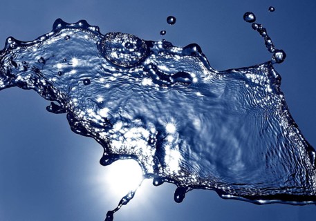 Water frozen by short exposure moving in backlight in front of the sun, duplex toning in blue