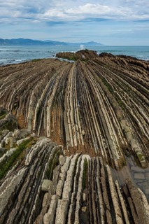 Distinctive rock cliffs as a geological formation of rock layers, Flysch on Itzurun Beach in