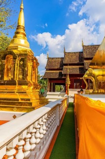 Gilded temple tower, chedi, stupa, and gilded elephant statue in the Wat Phra Singh Buddhist temple