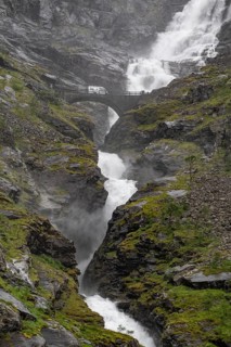 Motorhome on a bridge in front of heavily swollen Stigfossen waterfall, Trollstigen, near Åndalsnes