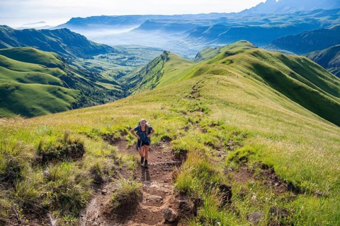 Female hiker on the hiking trail to Cathedral Peak, Green Mountains and Hills, Drakensberg