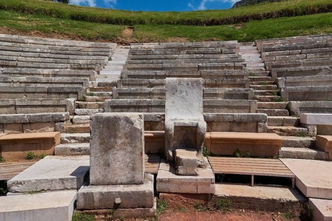 Ancient rows of stone amphitheatre in front of green landscape, ancient site, archaeological site,