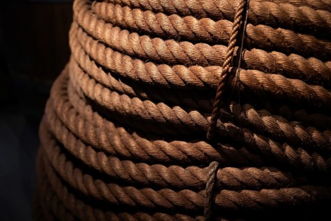 Close-up, thick rope layered on top of each other, illuminated in contrast between light and