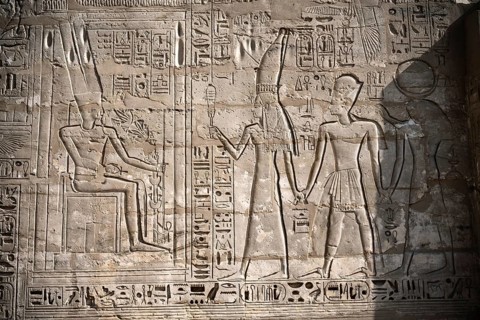 Close up details of ancient Egyptian history shown in reliefs and hieroglyphs inside Medinat Habu,