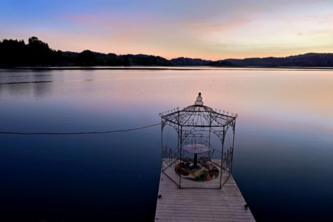 Table with two chairs on a pier at Lac d'Aiguebelette, Great Natural Lake, Aiguebelette-le-Lac,