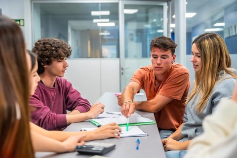 Group of young university students meeting, discussing, and collaborating on a study project in a