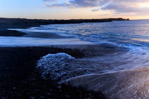 Lanzarote, Canary Islands, Spain, Europe, Los Hervideros, waves break gently on the beach during a