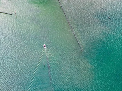 Motorboat entering the port of moss. Waves form on the surface of the water. The water level in