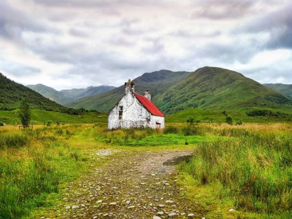 Athnamulloch Bothy cottage in front of renovation, white walls and red roof, historic stone