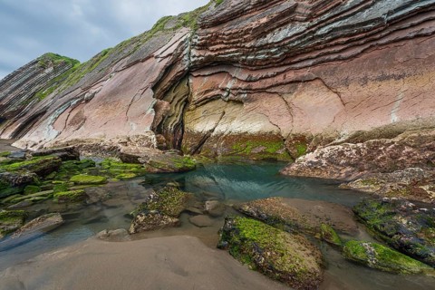 Distinctive rock cliffs as a geological formation of rock layers, Flysch on Itzurun Beach in