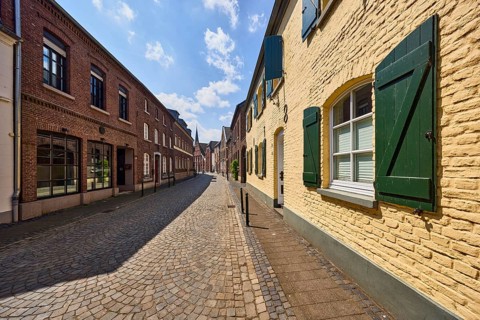 Street, historic brick buildings, buildings, houses, façade with windows and shutters, barrier