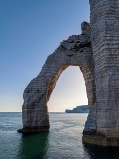 Aerial view of Porte d'Aval rock gate in backlight, famous sights and natural beauty on the chalk