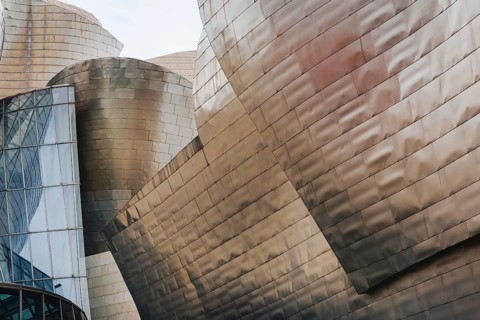 Exterior view of the Guggenheim Museum with titanium plates and glass elements in Bilbao, Spain