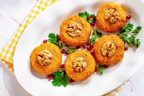 Pumpkin phali, Georgian dish, on a white plate, pumpkin appetizer with nuts and spices, no people,