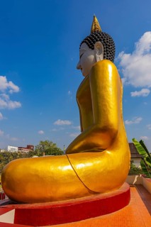 Huge gilded sitting Buddha, in front of the Wat Phra That Doi Kham Buddhist temple complex, Chiang