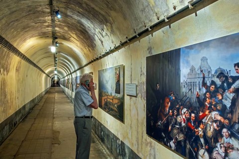 Visitor in underground corridor at Fort Eben-Emael, Belgian WW2 fortress neutralized by German