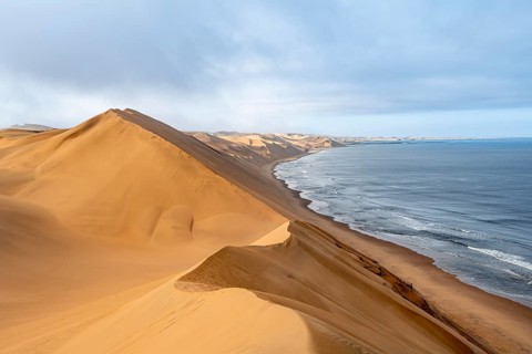 Sand dunes and sea in the morning, Atlantic coast and sandy desert with sea of dunes, Sandwich