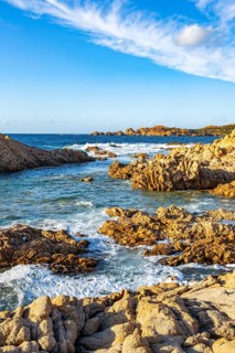 Landscape of the coastline with blue water at Marinedda Coast on a sunny day, Sardinia, Italy