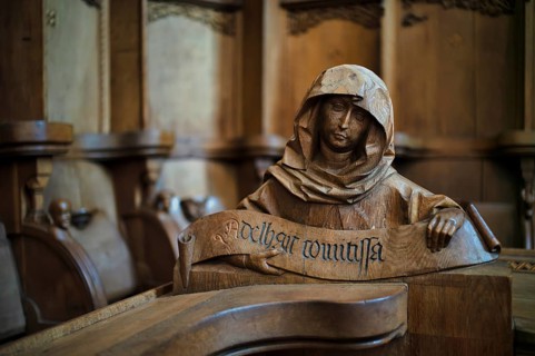 Interior photo, carved half-figure, man with headdress, oak choir stalls for monks' hour prayers,