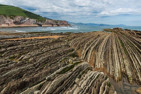 Distinctive rock cliffs as a geological formation of rock layers, Flysch on Itzurun Beach in