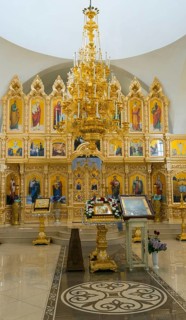 A magnificent interior of a church with a golden iconostasis and religious paintings, Nicoreni