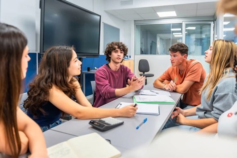 Young students actively participate in a collaborative study group, discussing project ideas and