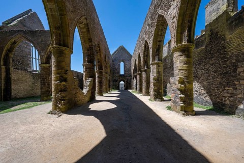 Perspective view of the medieval rows of pillars and pointed arches of the Gothic church ruins and