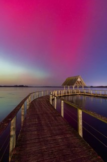 Wooden jetty and Northern Lights, Aurora borealis, polar lights over Lake Hemmelsdorf,