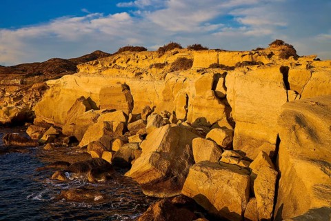 Rough rocky coast in golden light on a sunny day by the sea, Aspragremna, White Cliffs, Mavorspilia