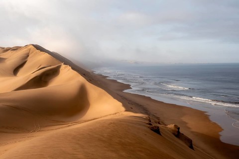 Sand dunes and sea, Atlantic coast and sandy desert with sea of dunes, Sandwich Harbour, Namib