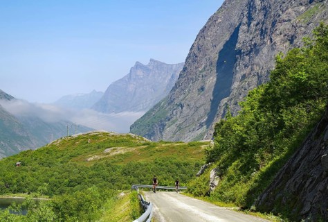 Cyclists on a mountainous, spectacular road surrounded by green nature, Eikesdalen, Eikesdalvatnet,