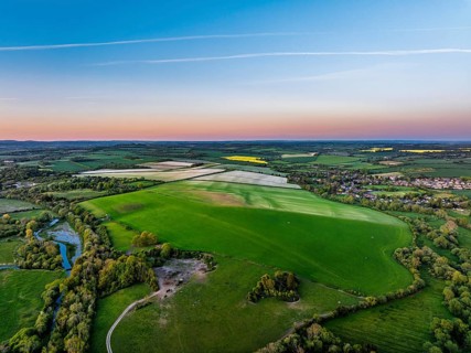 Sunset of Fields and Farms over Horsebridge nad Stockbridge from a drone, Hampshire, England,