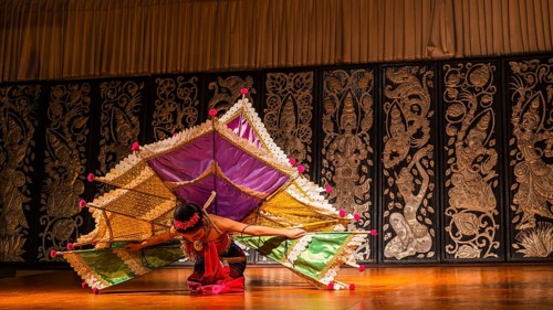 Young Thai woman with fan-like wings showing a traditional dance, Old Chiang Mai Cultural Center,