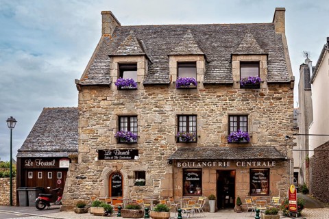 Historic stone house with floral decoration and outdoor areas, cozy atmosphere, historic stone