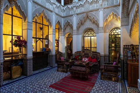 Oriental courtyard with carpet and beautiful furnishings at Hotel Riad Palais Sebhan, former city