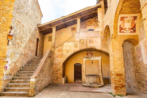Old town with historic buildings at San Gimignano on a sunny day, Tuscany, UNESCO World Heritage,