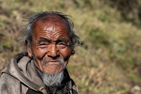 Portrait, elderly Nepalese man, native of the Tsumba Tibetan ethnic group, Tsum Valley, Himalayas,