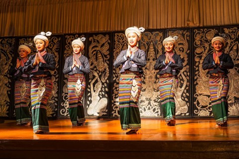 Young Thai women in traditional dress showing a traditional dance, Old Chiang Mai Cultural Center,