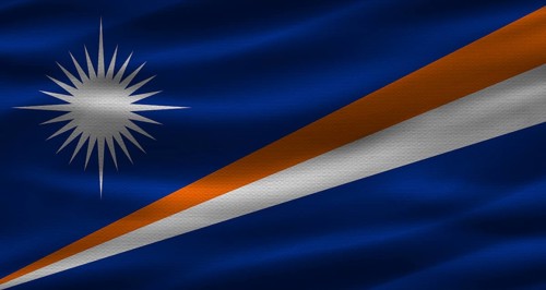 Marshallese flag with fabric texture. Realistic flag of Marshall Islands waving
