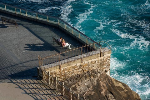 Couple looking at the sea on the seafront in San Sebastian, Spain