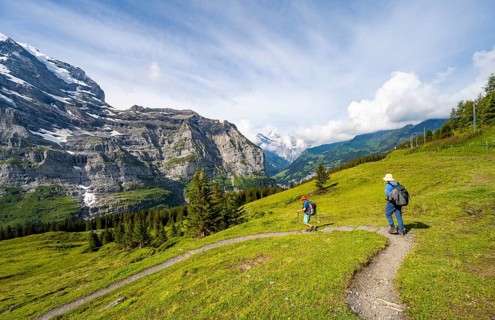 Two hikers on a hiking trail at Mettlenalp, Bernese Alps, Bernese Oberland, Switzerland