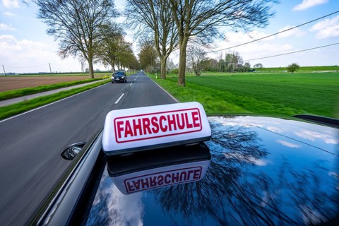 Symbolic picture driving school driving on a country road