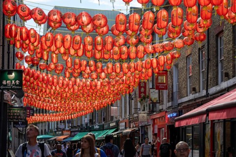 Red Chinese lanterns suspended over street in Chinatown, Gerard Street, Soho, London, England, UK